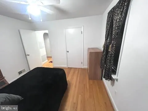 a view of a closet with wooden floor