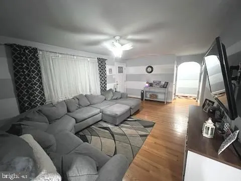 a living room with furniture and a large mirror