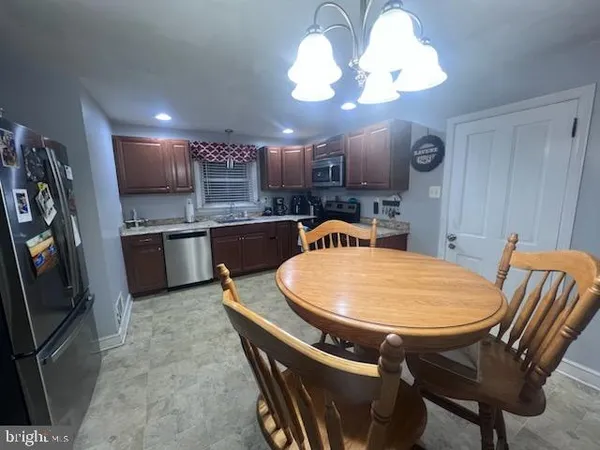 a large kitchen with a table and chairs in it