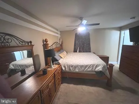 a spacious bedroom with a bed and a chandelier