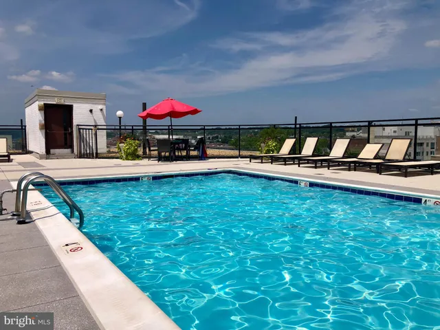 a swimming pool with outdoor seating and yard