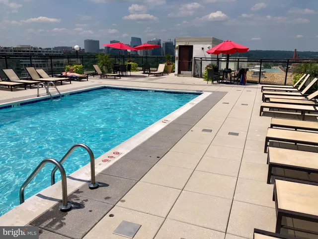 a view of a patio with a table and chairs under an umbrella