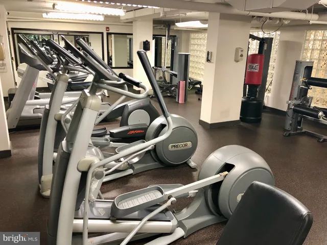 a kitchen with a stove a sink and a wooden floor