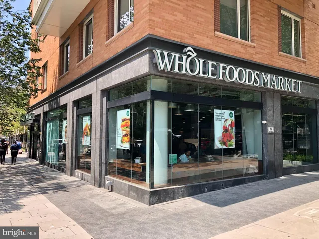 a view of multi story residential apartment building with a yard