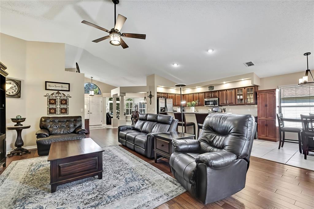 488 Fort Mill Lane Spring Hill, FL 34609 - Photo 12 of 54 a living room with furniture a ceiling fan and a rug