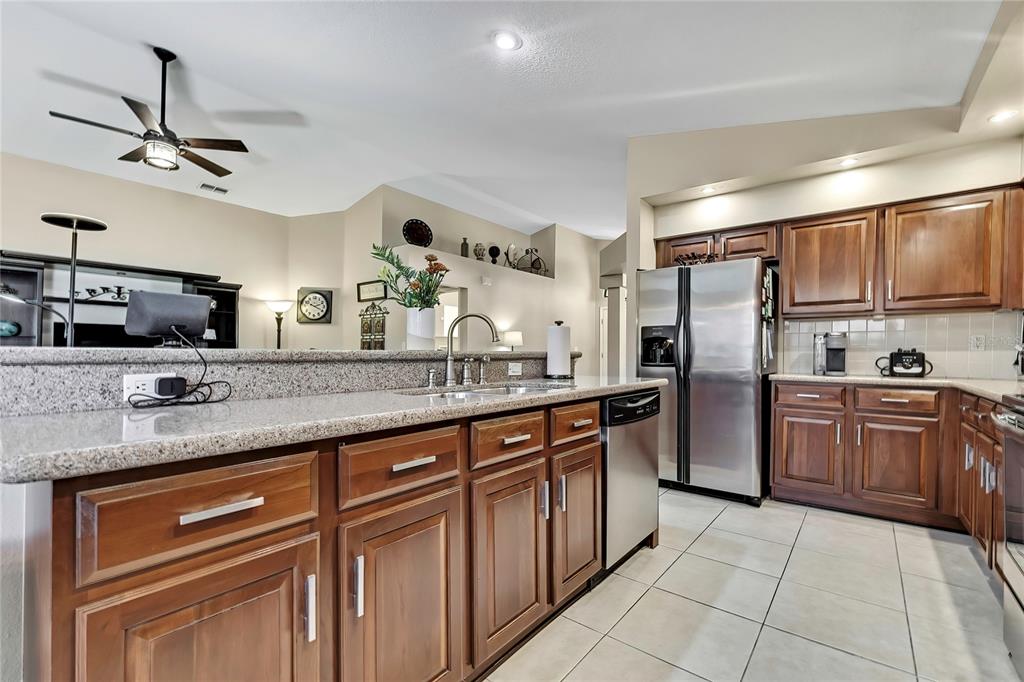 488 Fort Mill Lane Spring Hill, FL 34609 - Photo 16 of 54 a kitchen with stainless steel appliances granite countertop a sink and cabinets