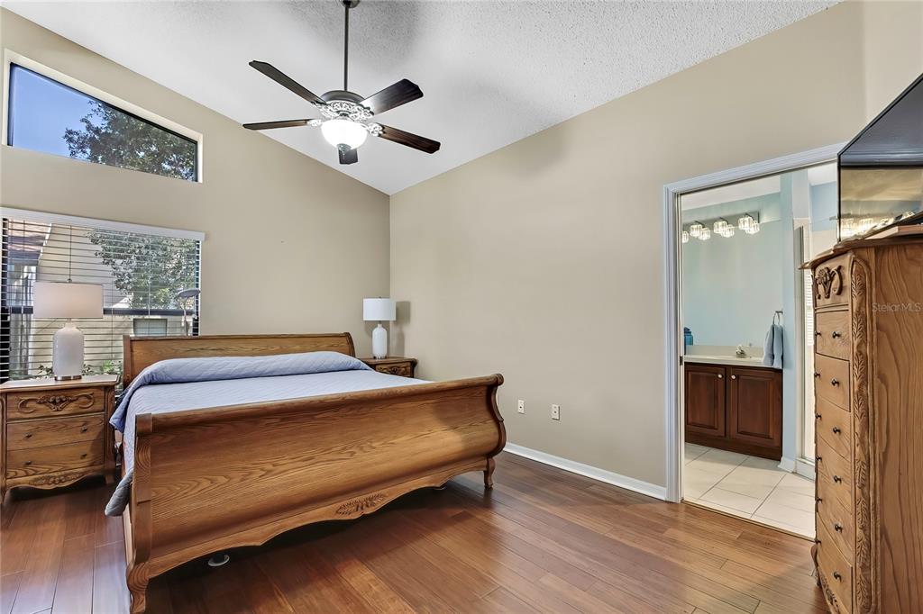 488 Fort Mill Lane Spring Hill, FL 34609 - Photo 18 of 54 a bedroom with a bed and a chandelier
