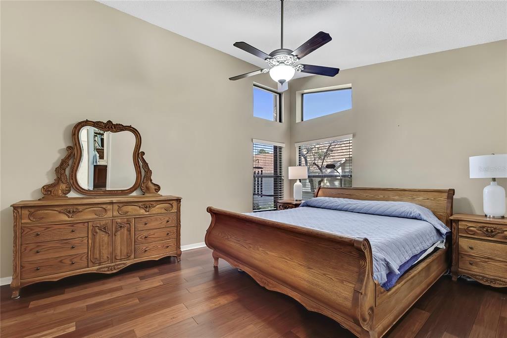 488 Fort Mill Lane Spring Hill, FL 34609 - Photo 19 of 54 a bedroom with a bed wooden floor and window