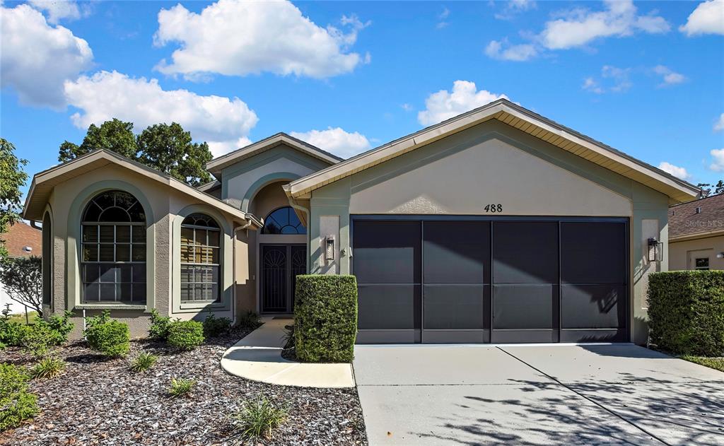 488 Fort Mill Lane Spring Hill, FL 34609 - Photo 2 of 54 a front view of a house with a yard