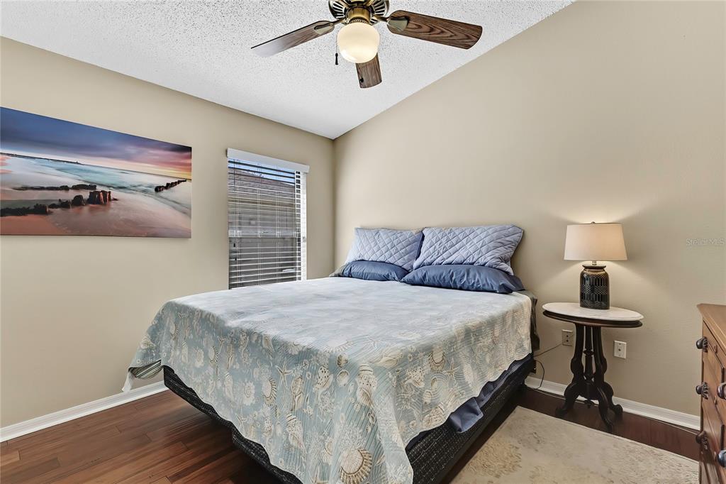 488 Fort Mill Lane Spring Hill, FL 34609 - Photo 23 of 54 a bedroom with a bed and a chandelier