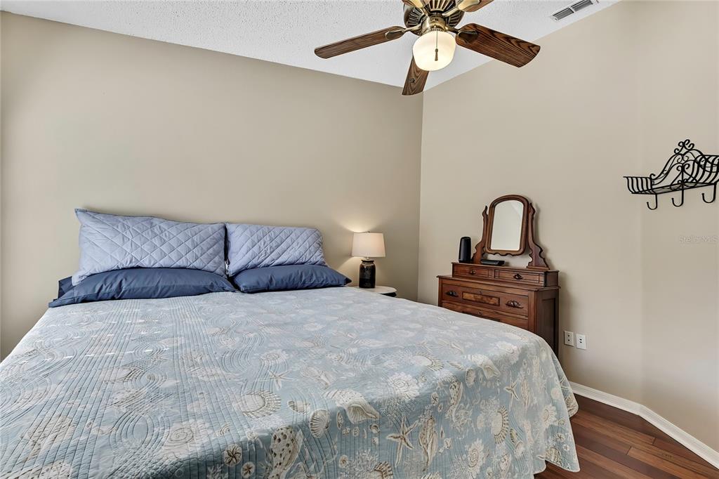 488 Fort Mill Lane Spring Hill, FL 34609 - Photo 24 of 54 a bedroom with a bed and a chandelier