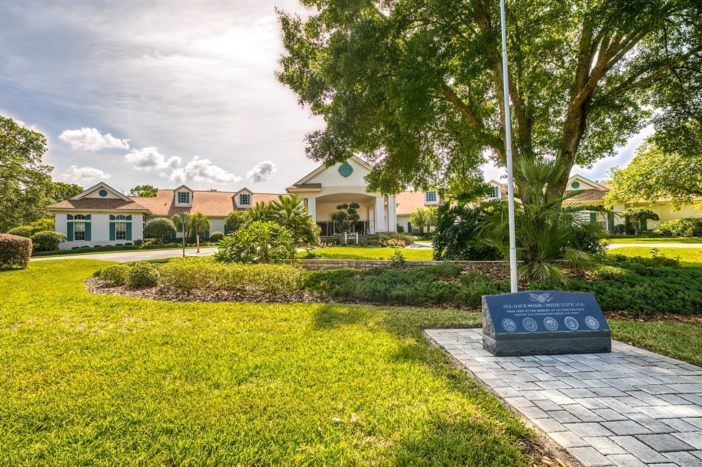 488 Fort Mill Lane Spring Hill, FL 34609 - Photo 39 of 54 a front view of a house with swimming pool garden and trees
