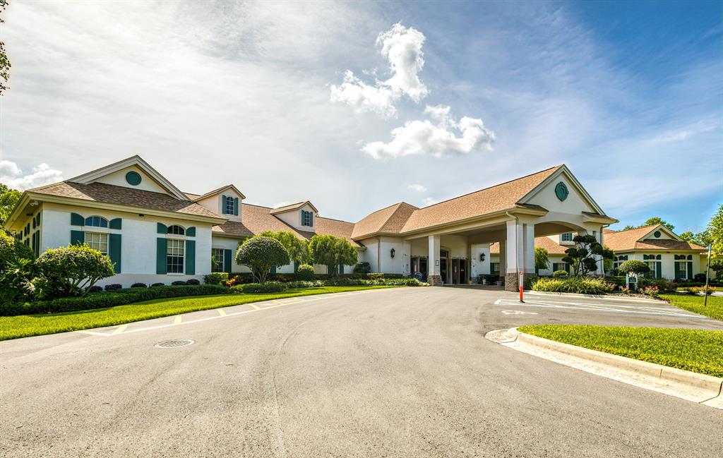 488 Fort Mill Lane Spring Hill, FL 34609 - Photo 40 of 54 a front view of a house with a yard and potted plants