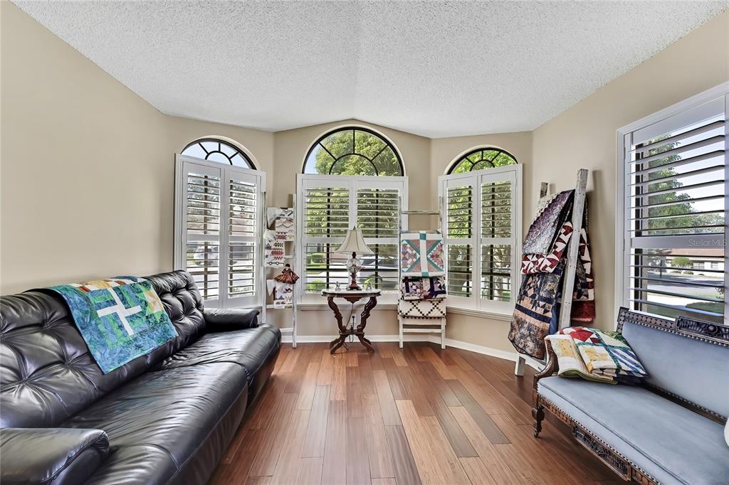 488 Fort Mill Lane Spring Hill, FL 34609 - Photo 4 of 54 a living room with furniture and a wooden floor