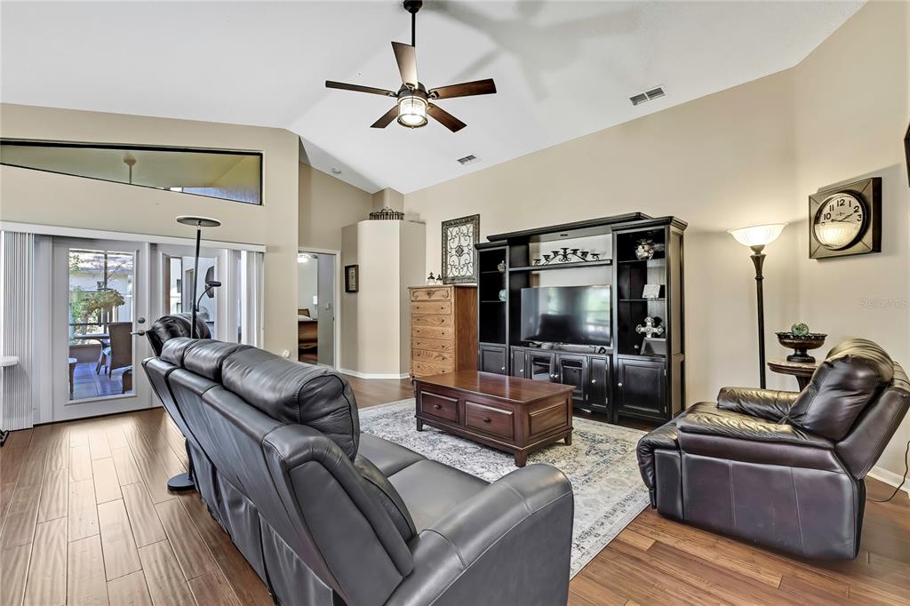 488 Fort Mill Lane Spring Hill, FL 34609 - Photo 10 of 54 a living room with furniture and a flat screen tv