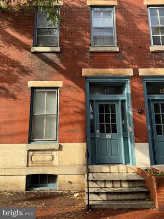 front view of a brick house with a small yard