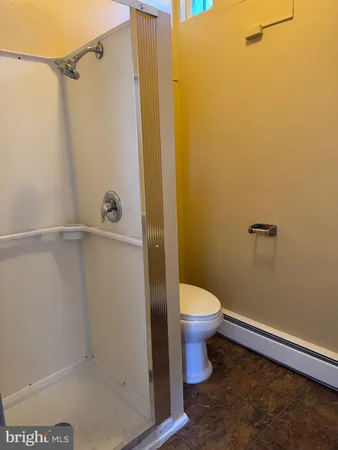 a bathroom with a toilet and a shower