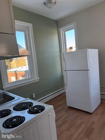 a kitchen with a refrigerator and a stove