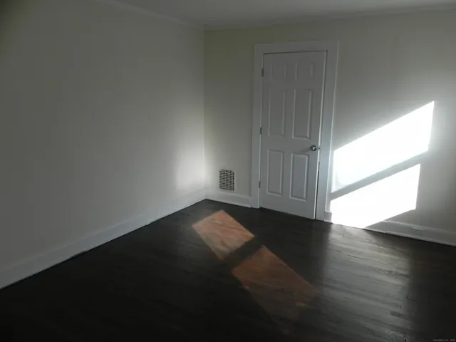 a view of wooden floor and windows in a room