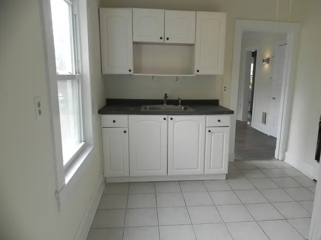 a kitchen with white cabinets