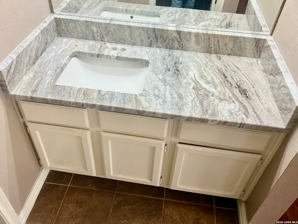 a bathroom with a sink and a mirror