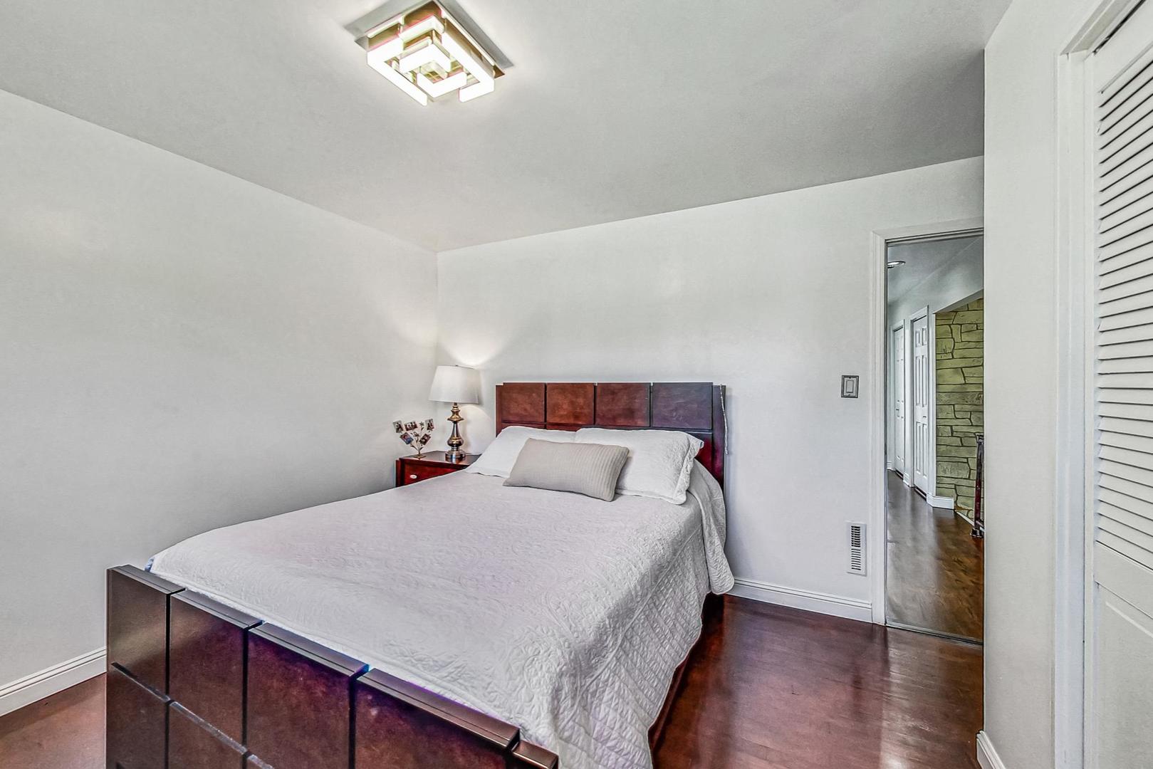 921 Crockett Avenue Addison, IL 60101 - Photo 11 of 34 a bedroom with a bed and a window