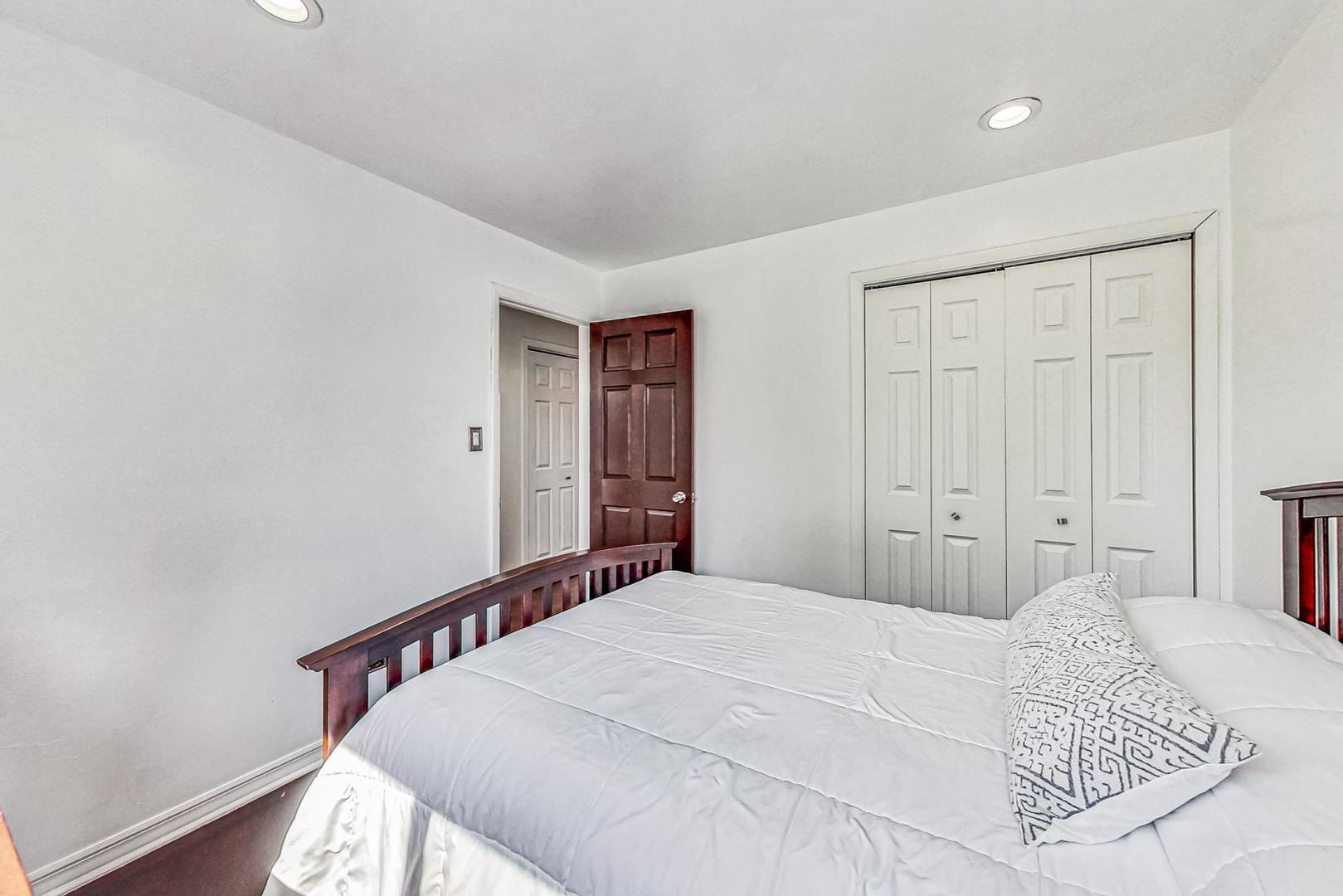 921 Crockett Avenue Addison, IL 60101 - Photo 16 of 34 a bedroom with a bed and a window