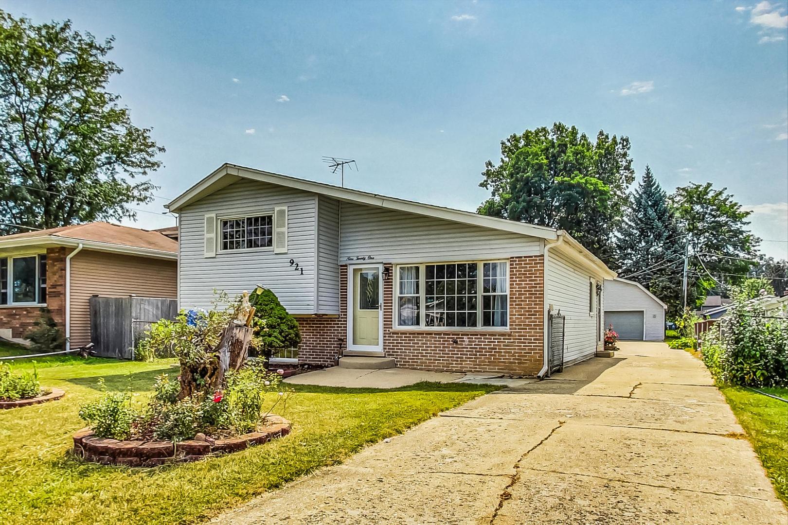 921 Crockett Avenue Addison, IL 60101 - Photo 2 of 34 a front view of a house with a yard garage and outdoor seating