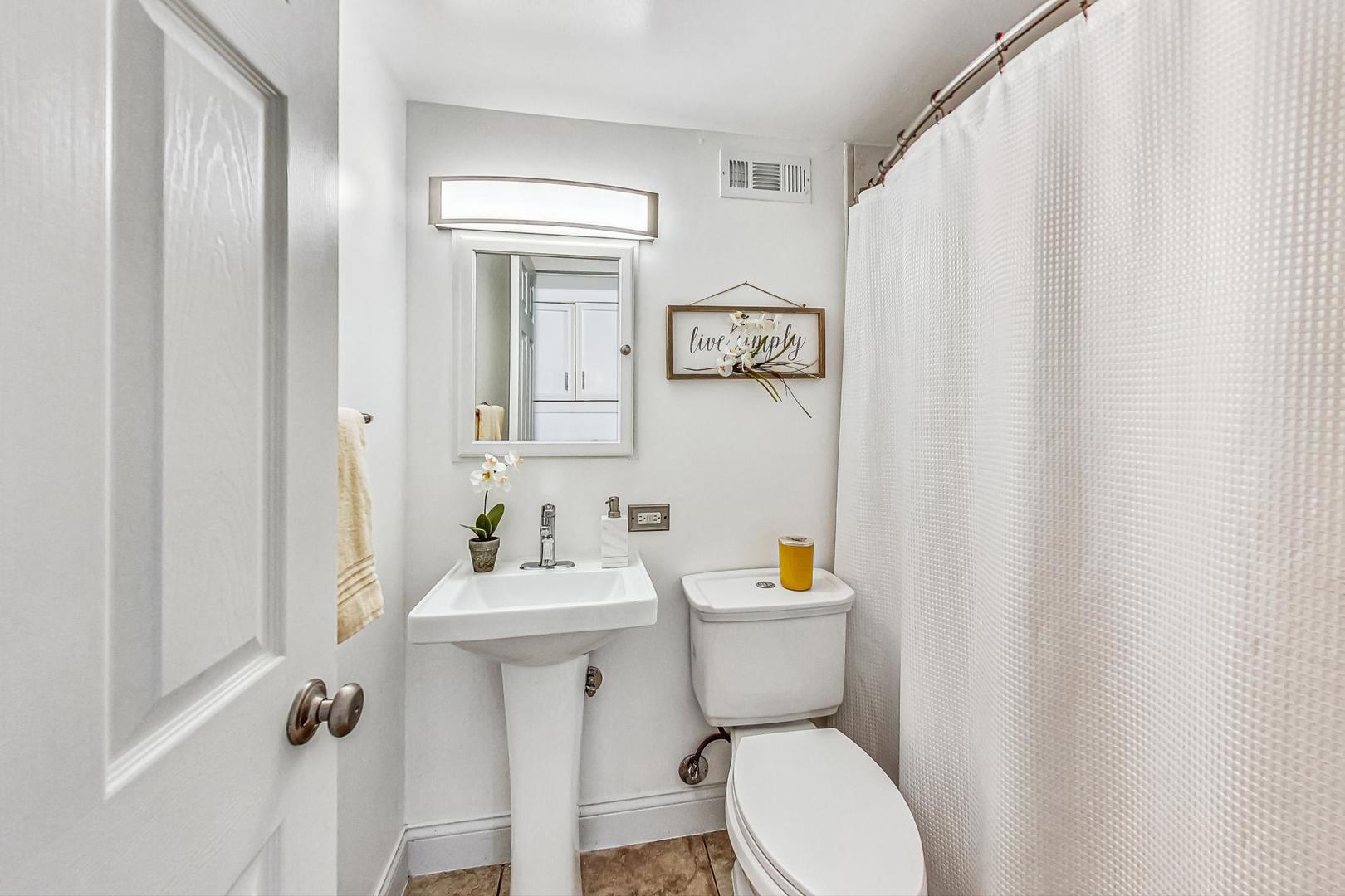 921 Crockett Avenue Addison, IL 60101 - Photo 23 of 34 a bathroom with a toilet a sink and a mirror