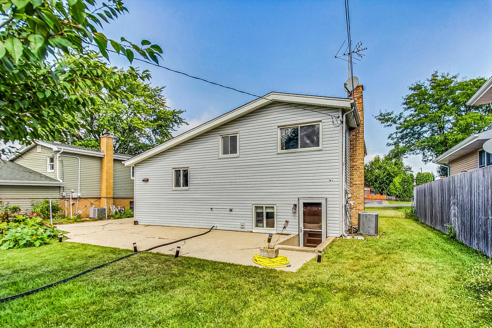 921 Crockett Avenue Addison, IL 60101 - Photo 28 of 34 a view of a house with backyard and sitting area