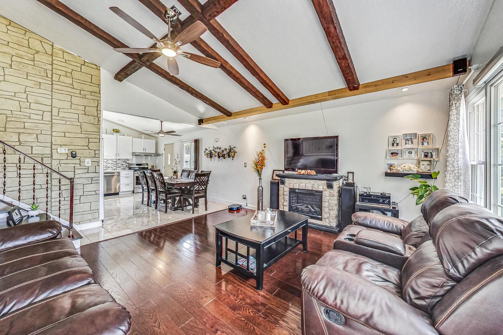 921 Crockett Avenue Addison, IL 60101 - Photo 3 of 34 a living room with furniture and a flat screen tv