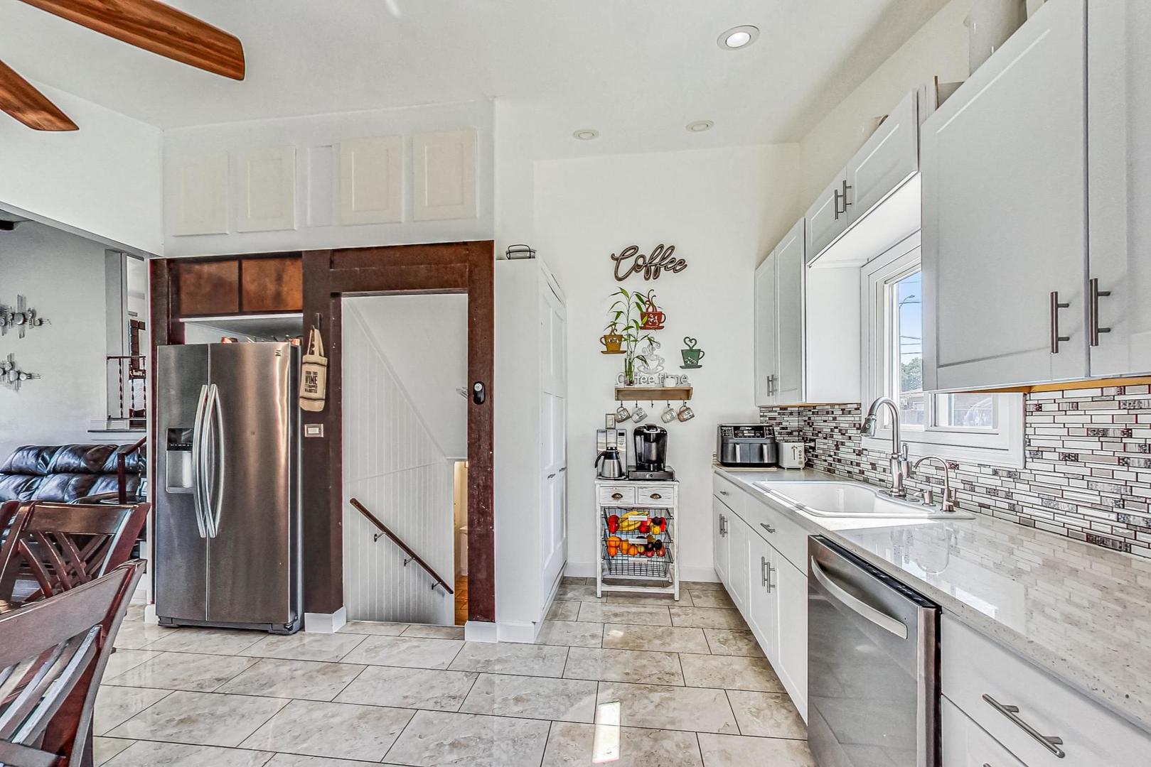 921 Crockett Avenue Addison, IL 60101 - Photo 8 of 34 a kitchen with stainless steel appliances granite countertop a refrigerator and a sink