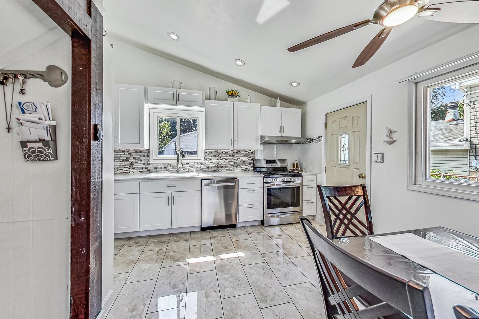 921 Crockett Avenue Addison, IL 60101 - Photo 9 of 34 a kitchen with a sink stove and cabinets