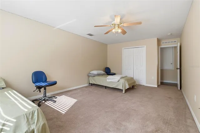 a white toilet sitting next to a white wall