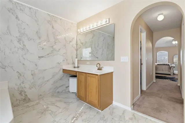 a bathroom with a sink a toilet and a mirror