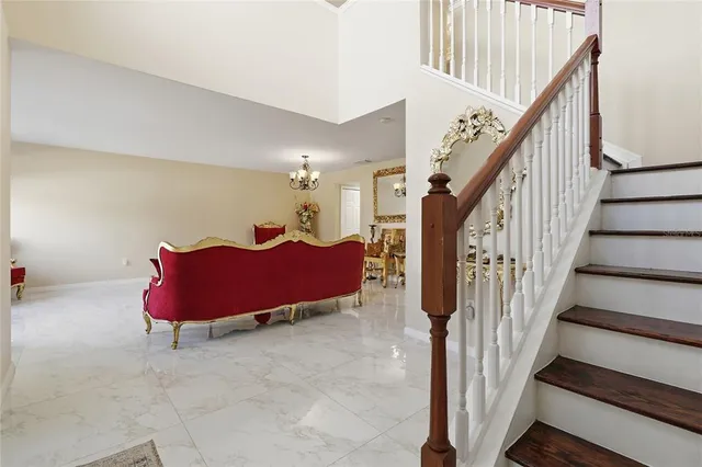 a living room with furniture and a chandelier