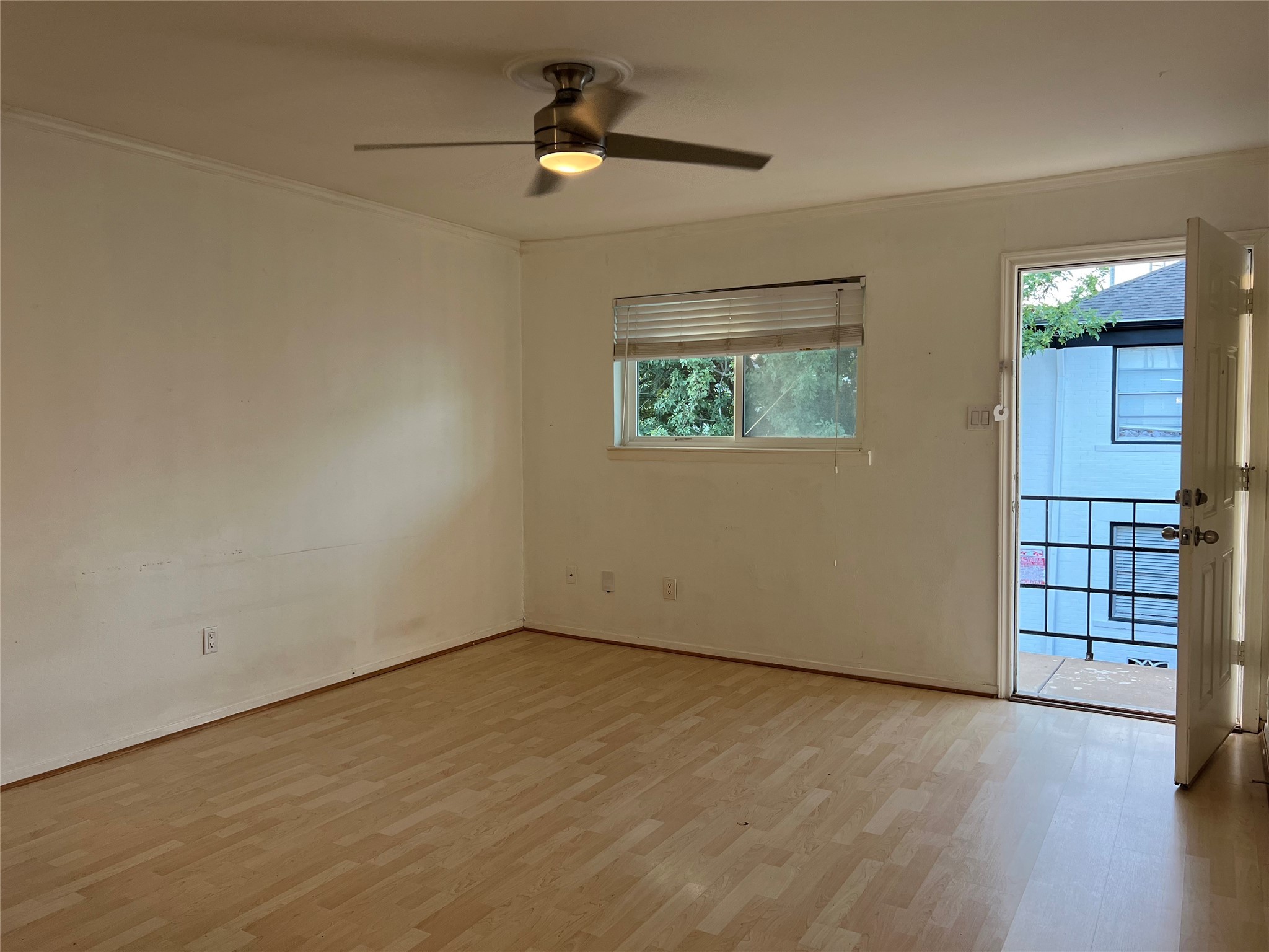 1851 West Main Street, Unit 3 Houston, TX 77098 - Photo 6 of 9 an empty room with ceiling fan and windows