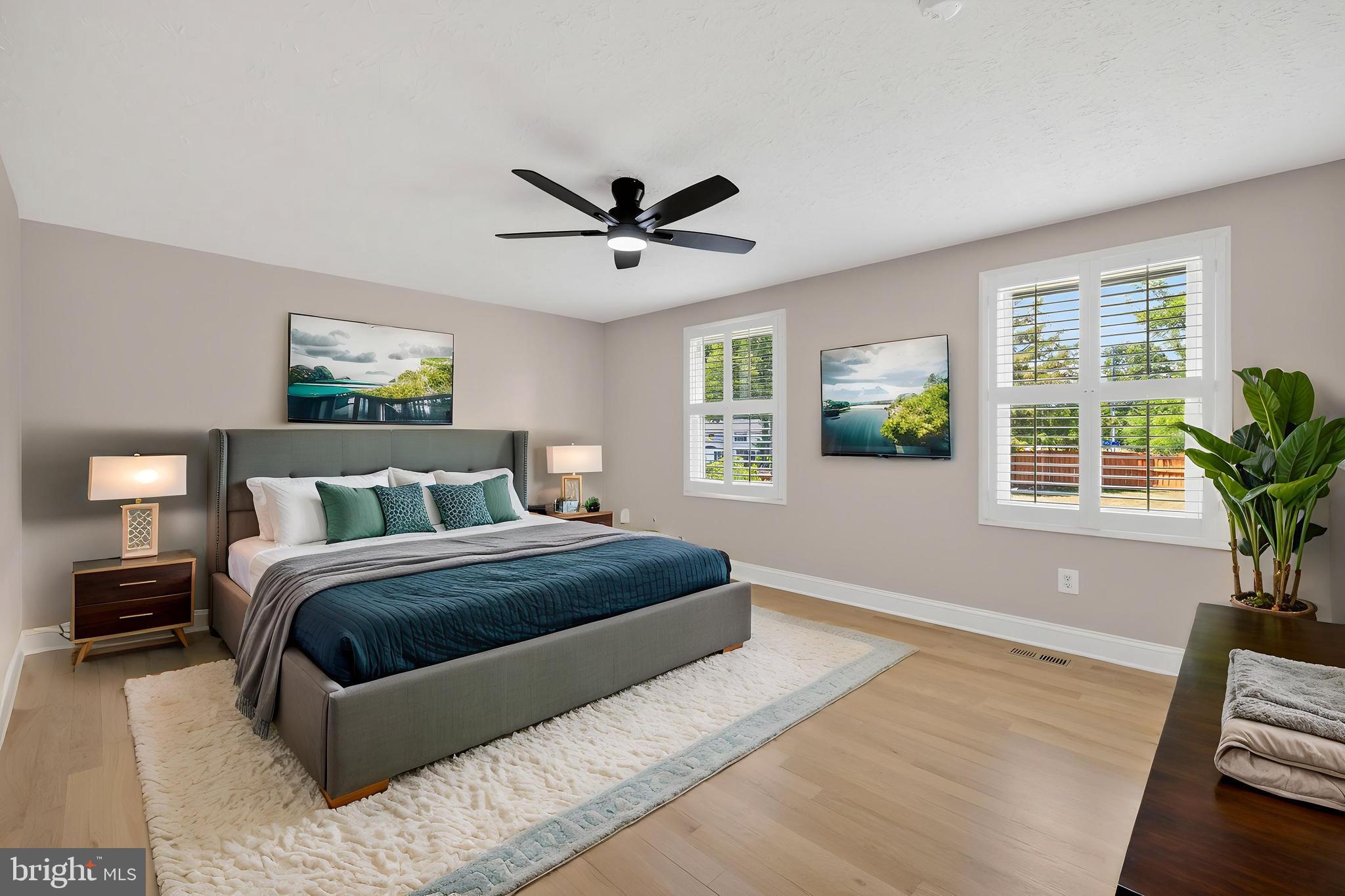 7518 Candytuft Court Springfield, VA 22153 - Photo 21 of 47 a spacious bedroom with a bed and wooden floor