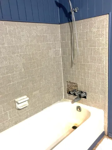 a bathroom with a toilet a sink and shower