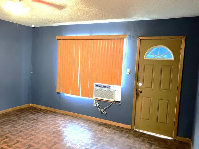 a bed sitting in a bedroom next to a large window