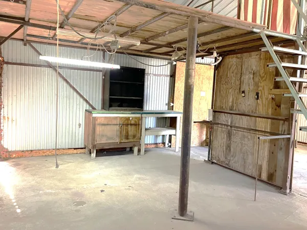 a view of a room with wooden walls and stairs