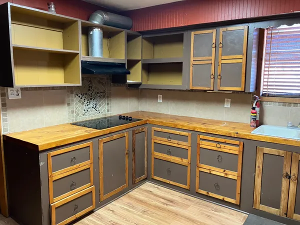 a kitchen with stainless steel appliances granite countertop a sink and a stove