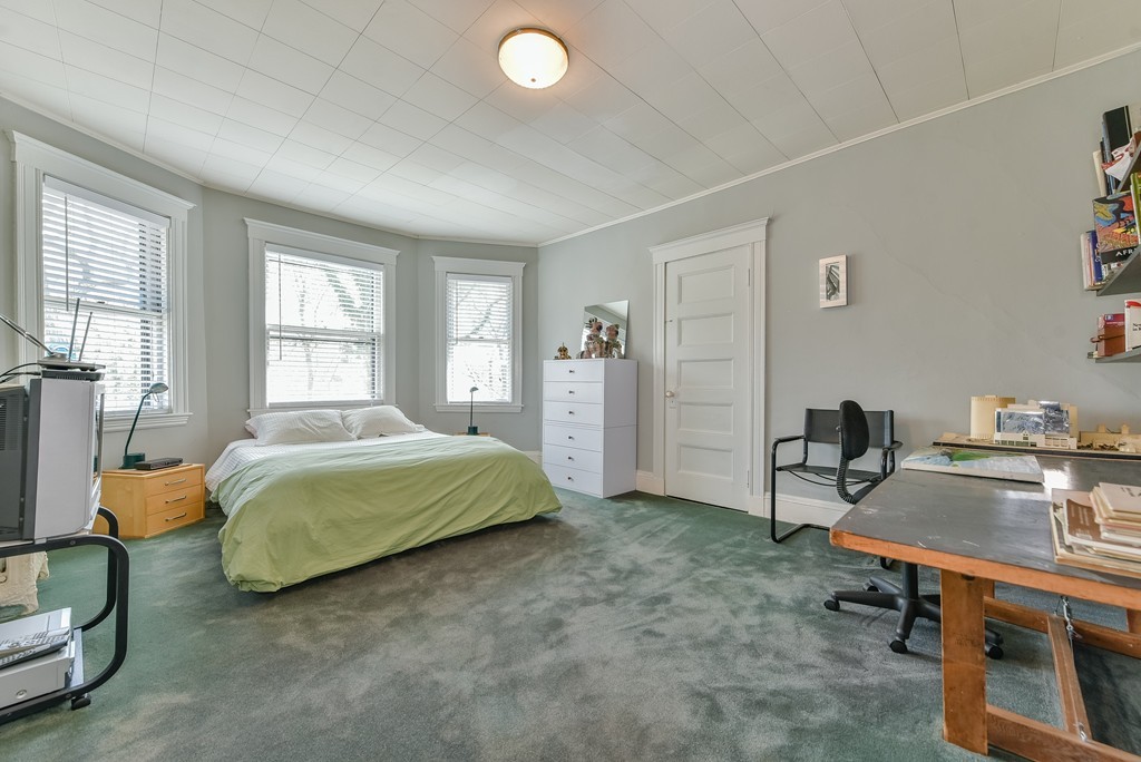 188 Rawson Road, Unit B Brookline, MA 02445 - Photo 16 of 21 a bedroom with a bed and a desk