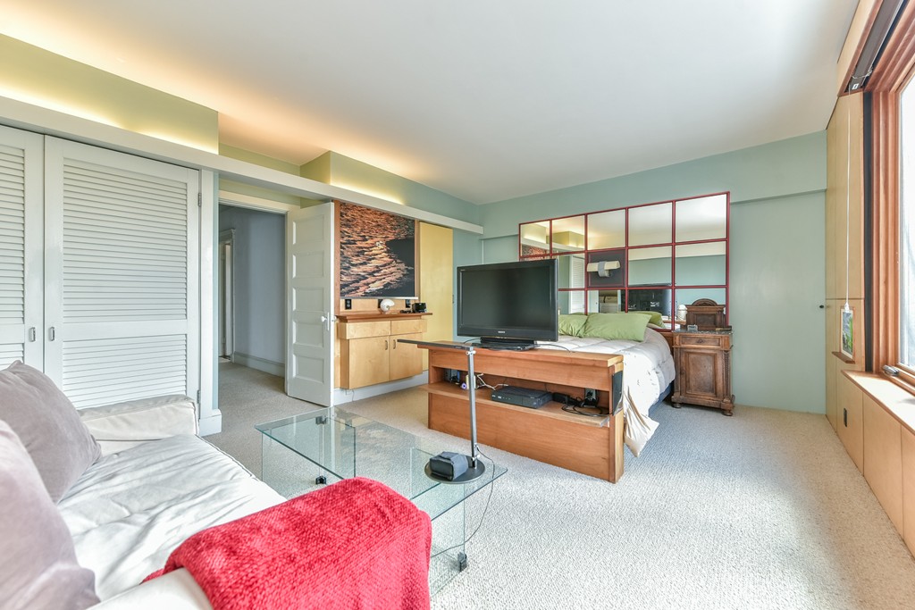 188 Rawson Road, Unit B Brookline, MA 02445 - Photo 19 of 21 a bedroom with furniture and a large window