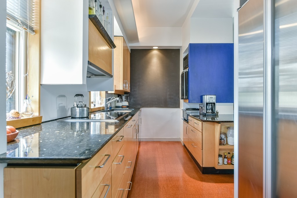 188 Rawson Road, Unit B Brookline, MA 02445 - Photo 9 of 21 a kitchen with stainless steel appliances granite countertop a sink a stove and a refrigerator