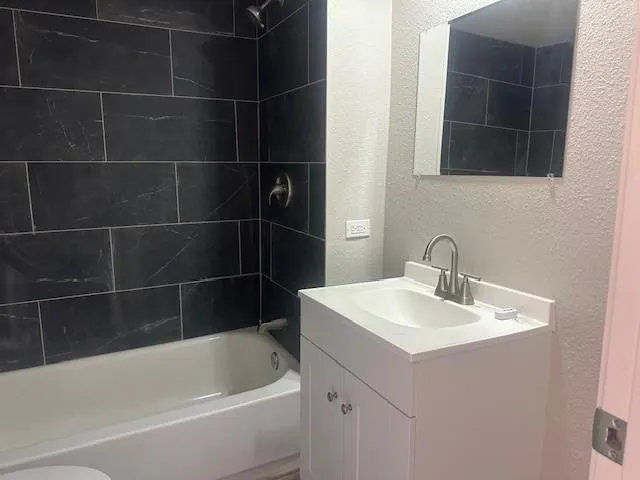 a white bath tub sitting next to a white sink