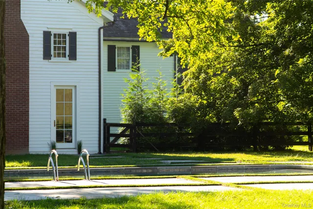 a view of a swimming pool with a table and chairs in front of it