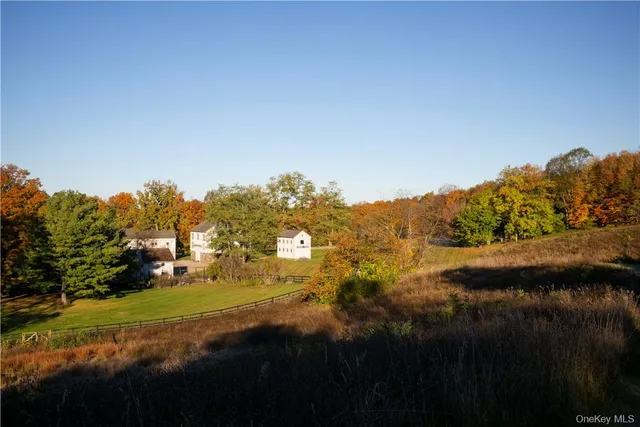 a view of a small house with a yard