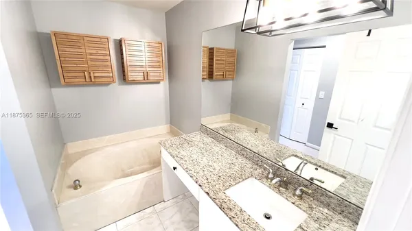 a bathroom with a bathtub and shower