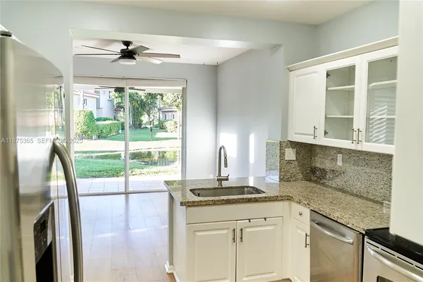 a kitchen with a sink and large window